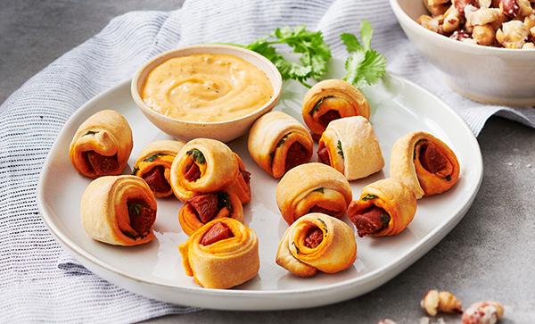 Chorizo Pigs in a Blanket with Sofrito-Truffle Mayo and Candied Chili-Garlic Peanuts
