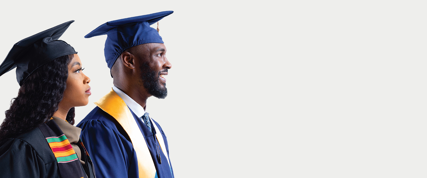 Black Man and Woman smiling in cap and gown