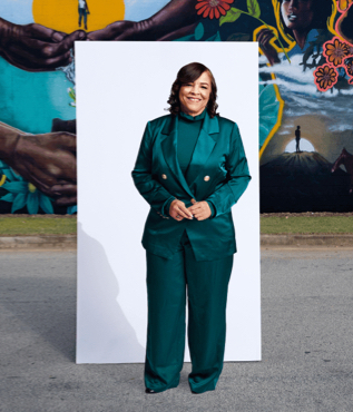 Cheryl Lowery in front of a white canvas