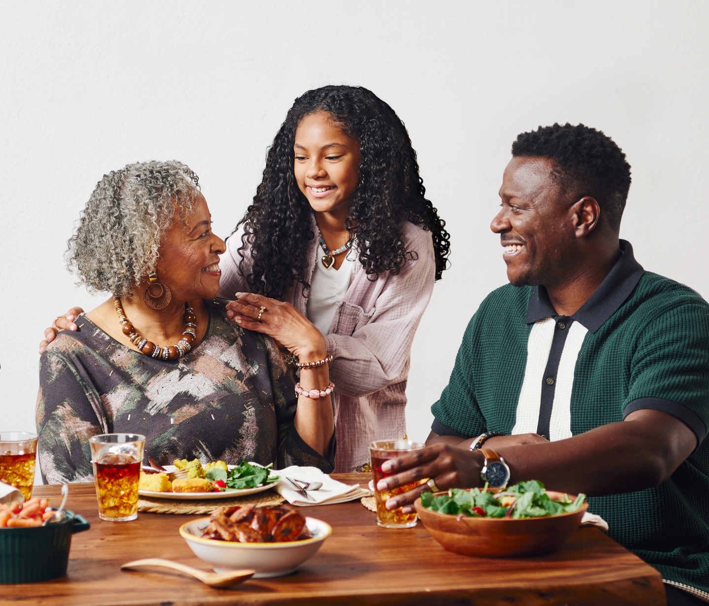 Family gathered around a table of food for sunday dinner