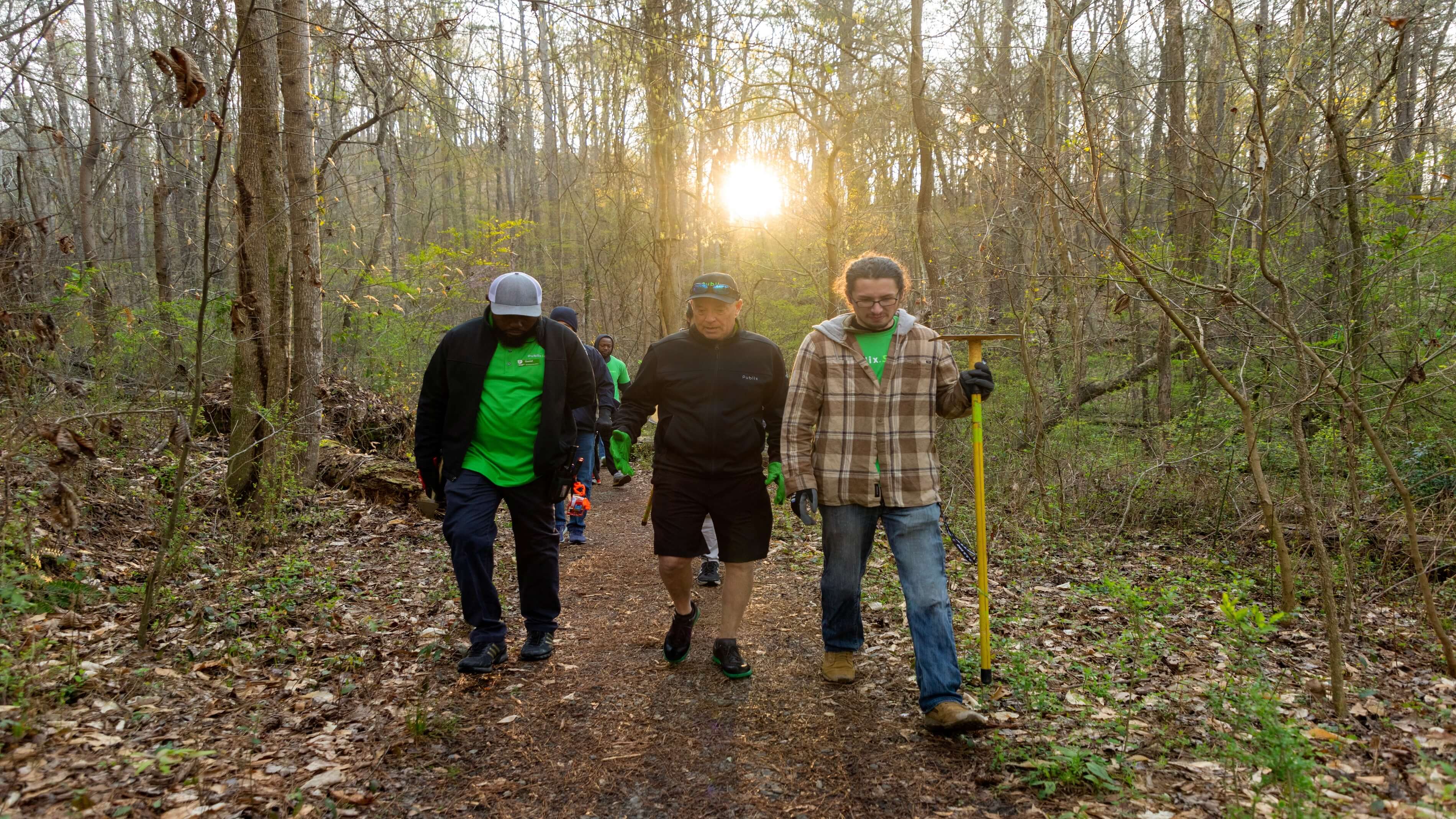 Publix CEO Todd Jones joins 60 Publix associates cleaning up trails and pulling invasive plants from water areas around Powers Island Trail during Publix Serves Week.
