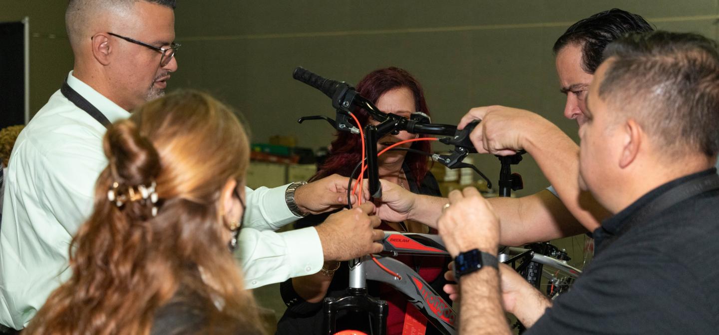 Publix leaders helping build bikes