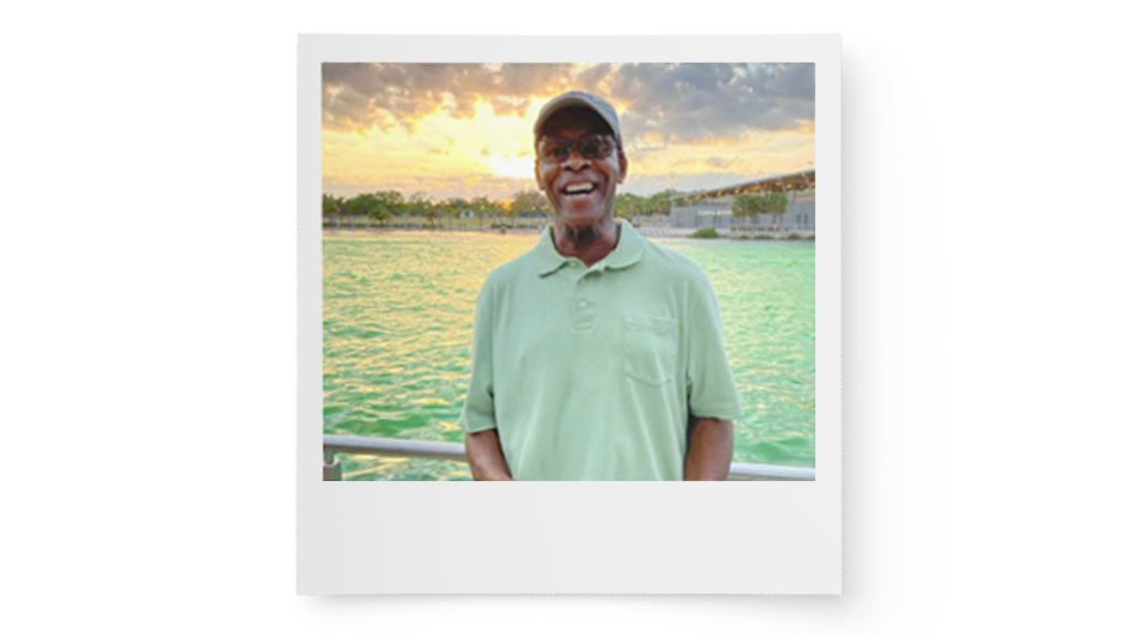 polaroid picture of Arthur in front of the ocean