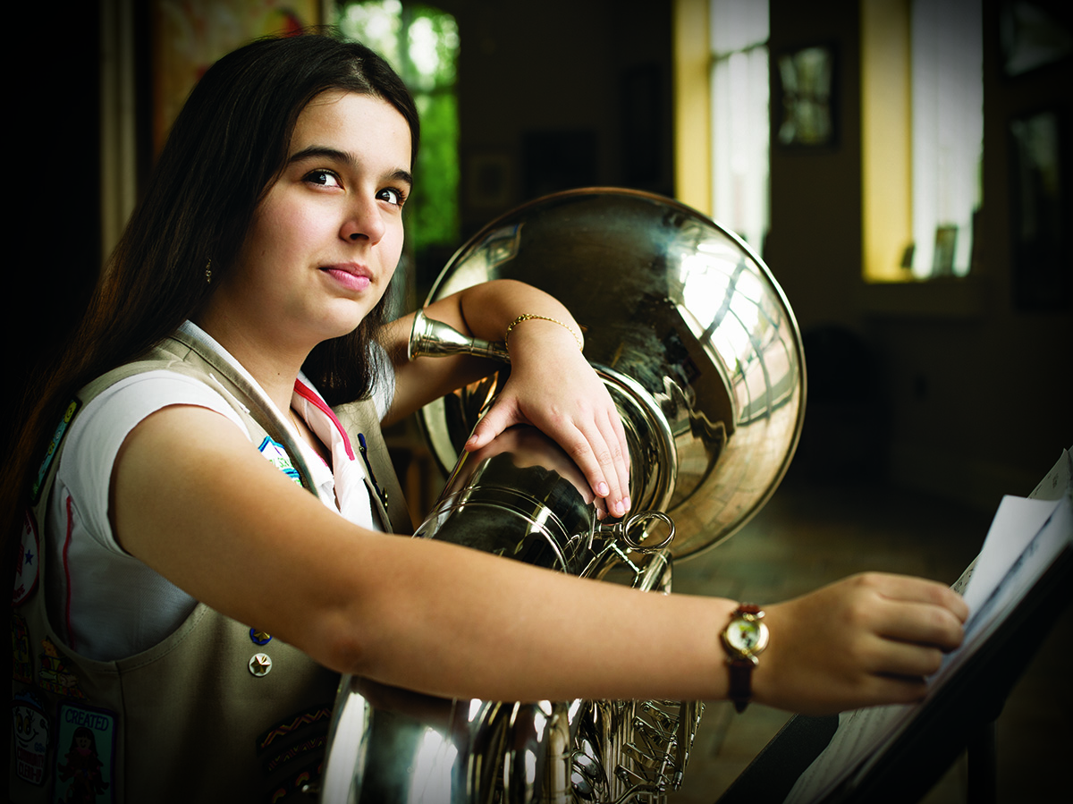 girl playing large brass instrument