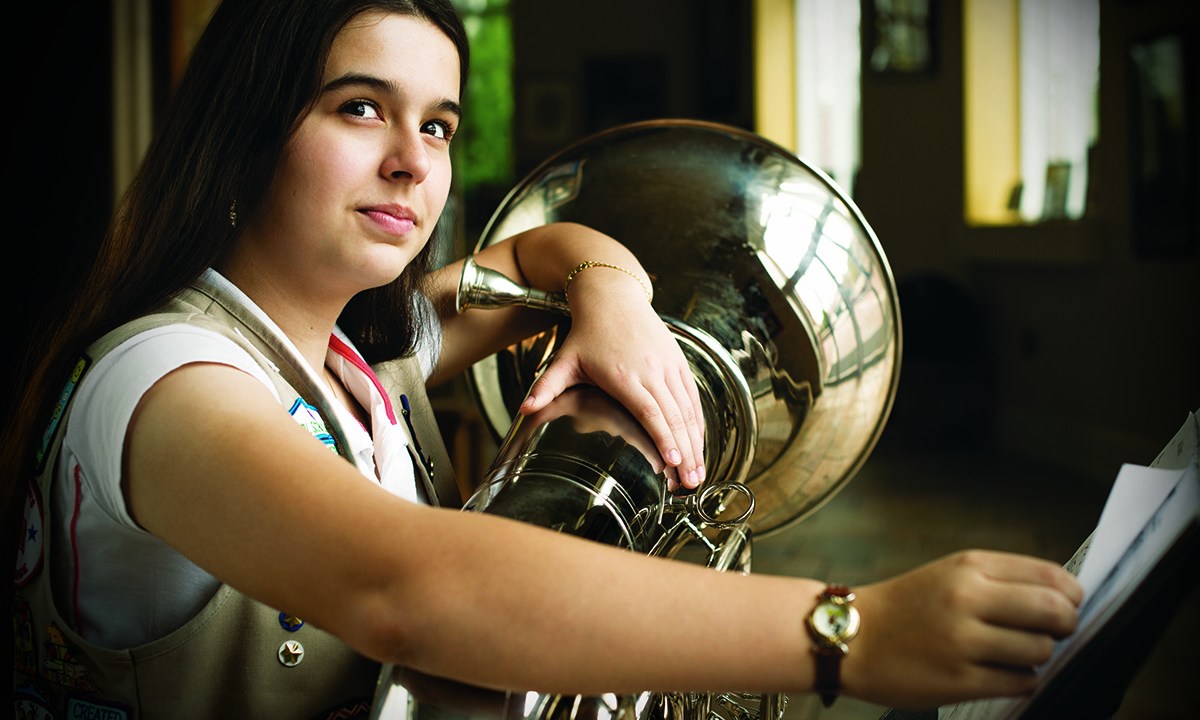 girl playing large brass instrument