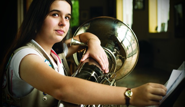 girl playing large brass instrument