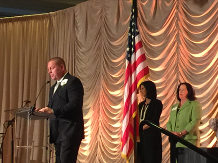 publix charities speech with american flag on stage