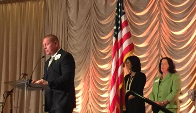 publix charities speech with american flag on stage