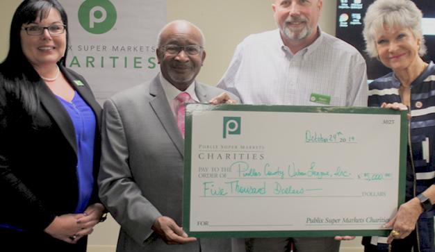 Publix Store Managers present Urban League of Pinellas County with a giant check.