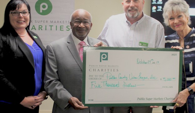 Publix Store Managers present Urban League of Pinellas County with a giant check.
