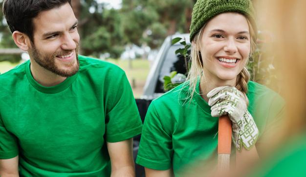 couple smiling while holding a shovel