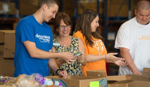 smiling publix charities volunteers working at a food bank