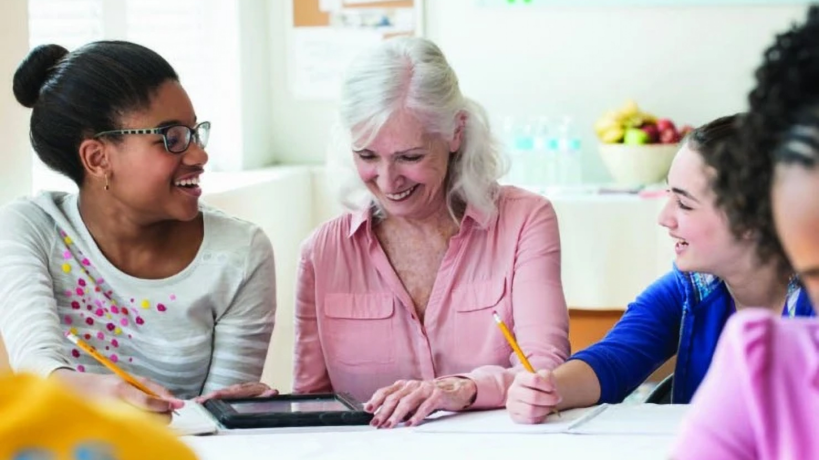 lady helping teens with homework