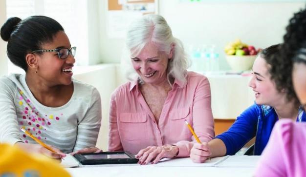 lady helping teens with homework