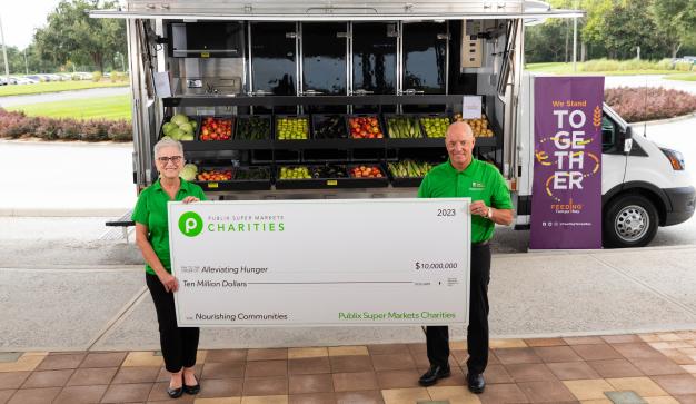 publix leadership holding a giant charities check