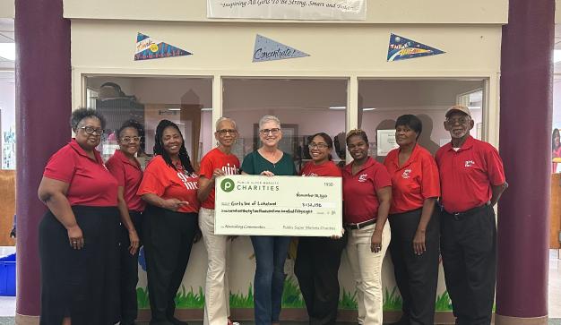 Group of people from Girls Inc. of Lakeland holding a charity check