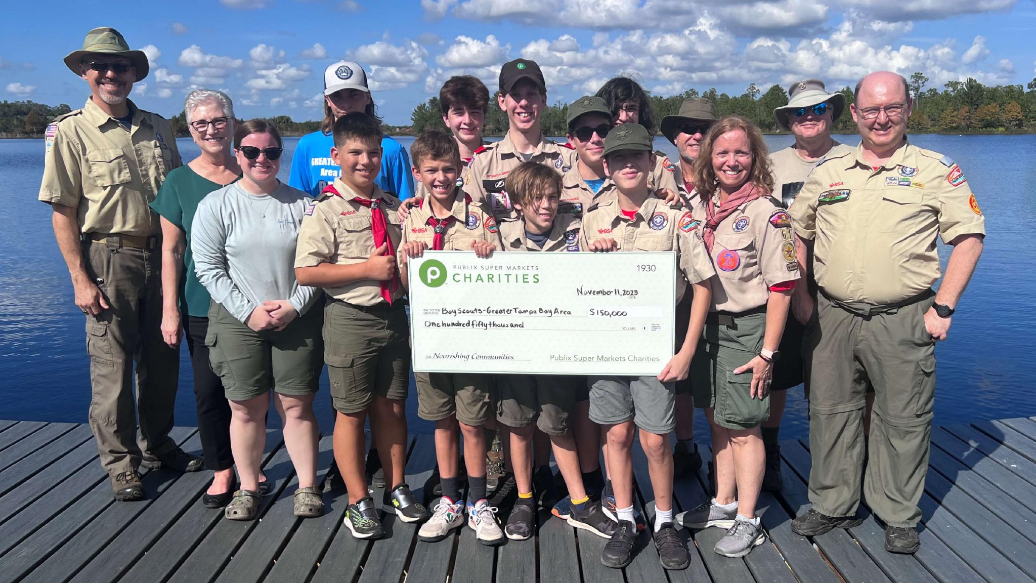 Boy Scouts of America posing with large check