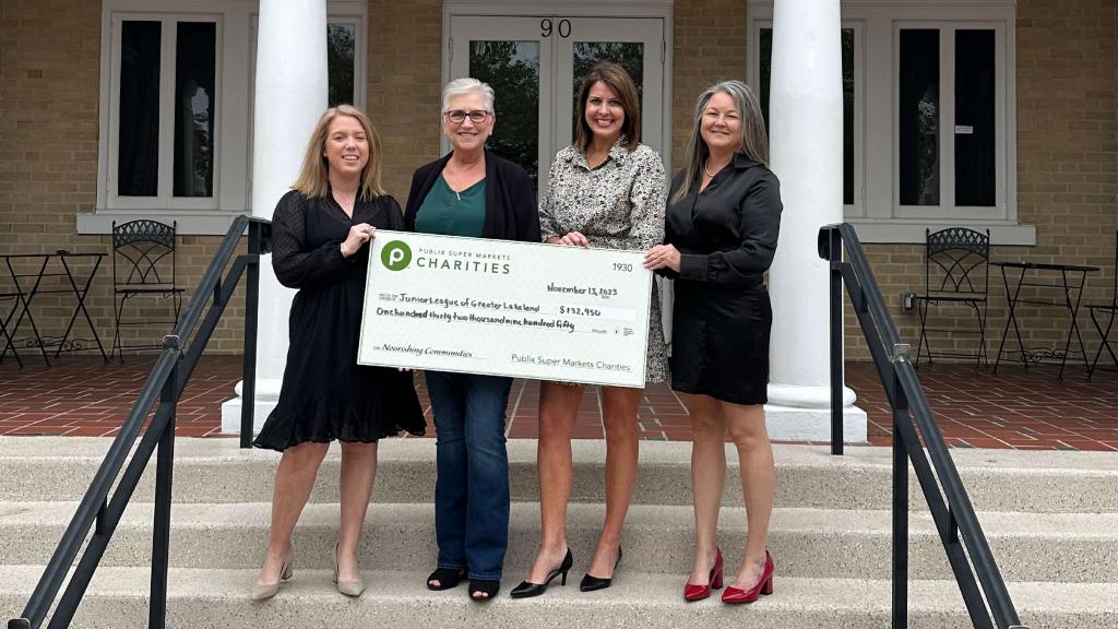 Junior League of Greater Lakeland holding a charity check