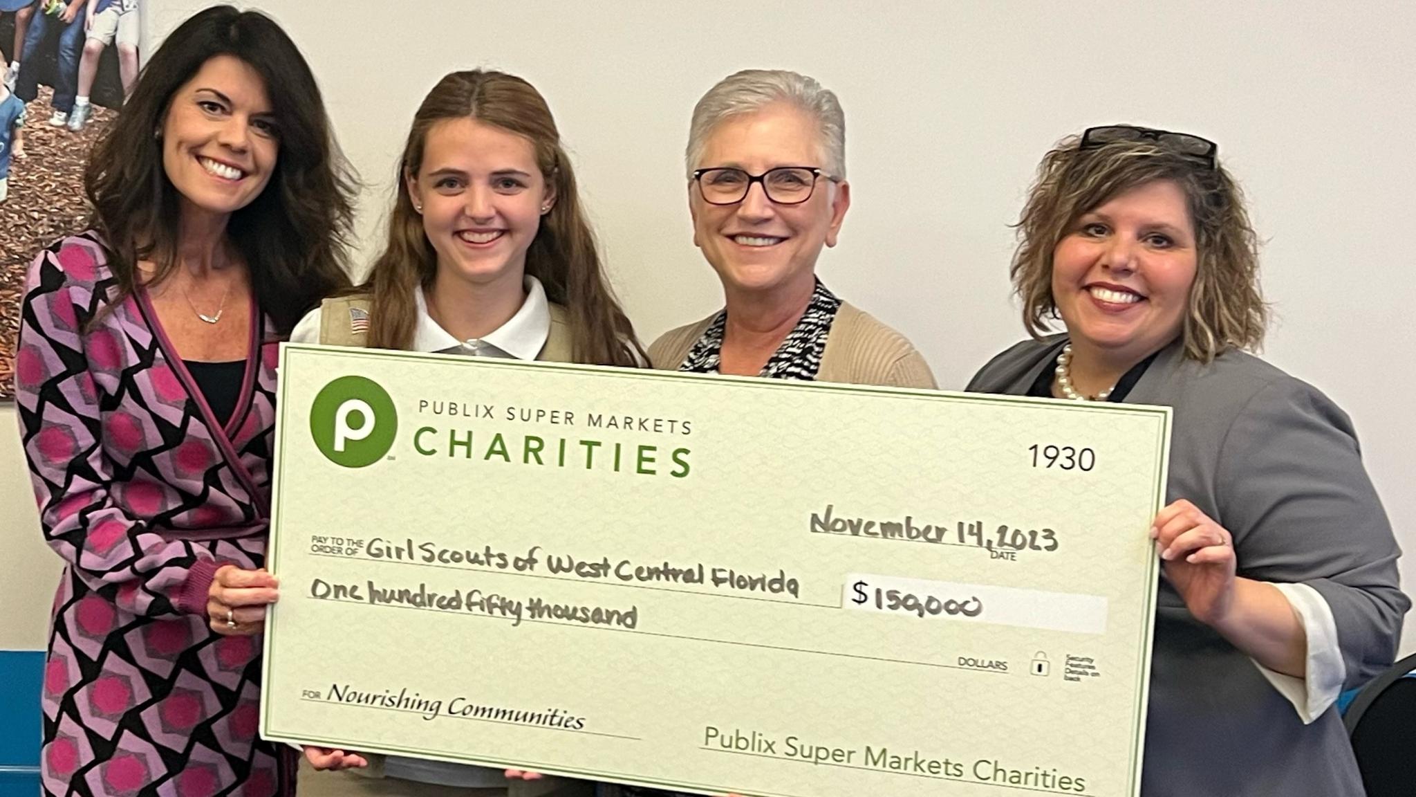 Girls Scouts of West Central Florida holding a charity check