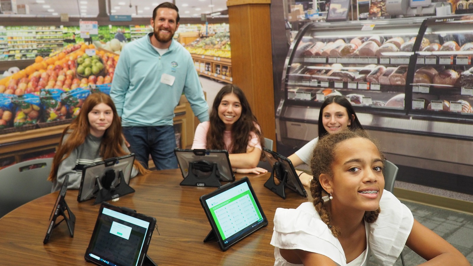 kids in a Publix super market with tablets
