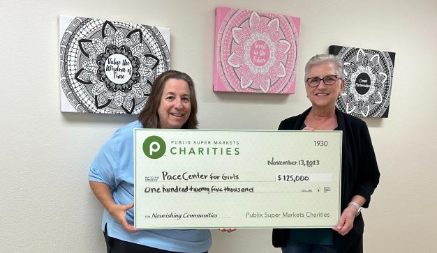 Two women holding a check for PACE Center for Girls