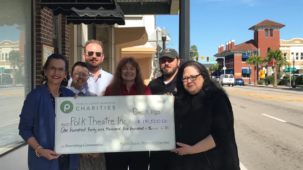 Group holding a check for the Historic Polk Theatre