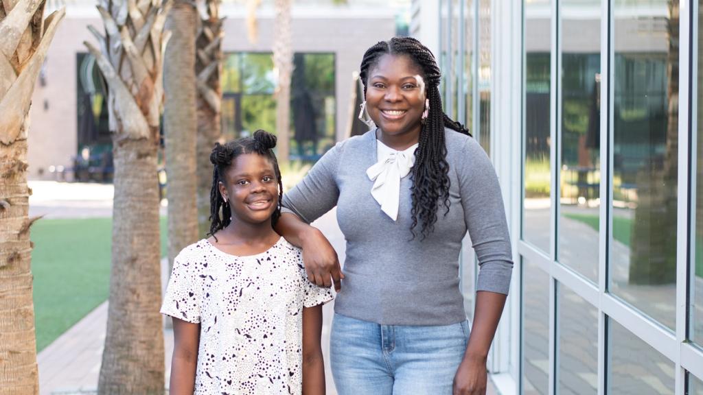 Mentor and mentee standing together