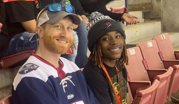 man and boy at a sports game