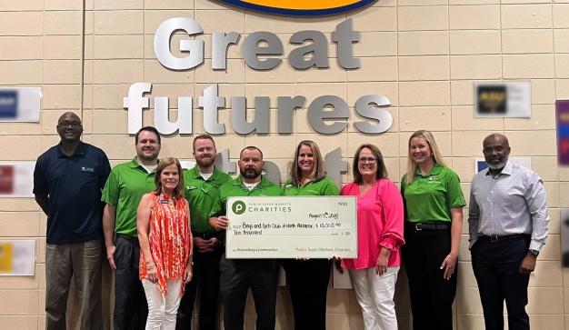 Publix store managers presenting charity check