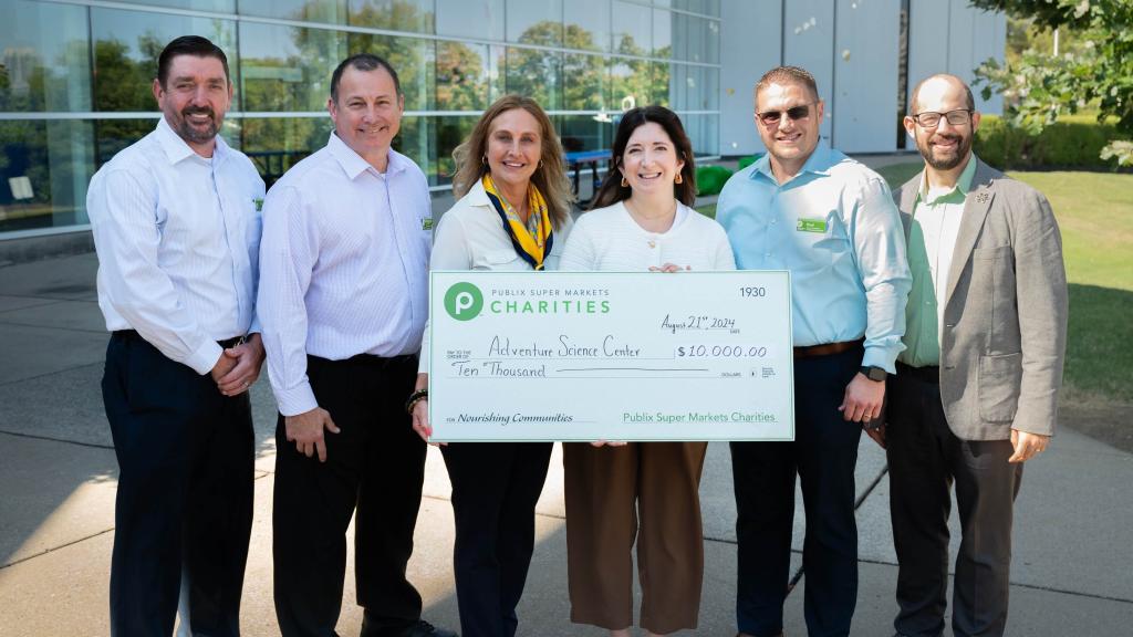Publix leadership holding a giant check for Adventure Science Center