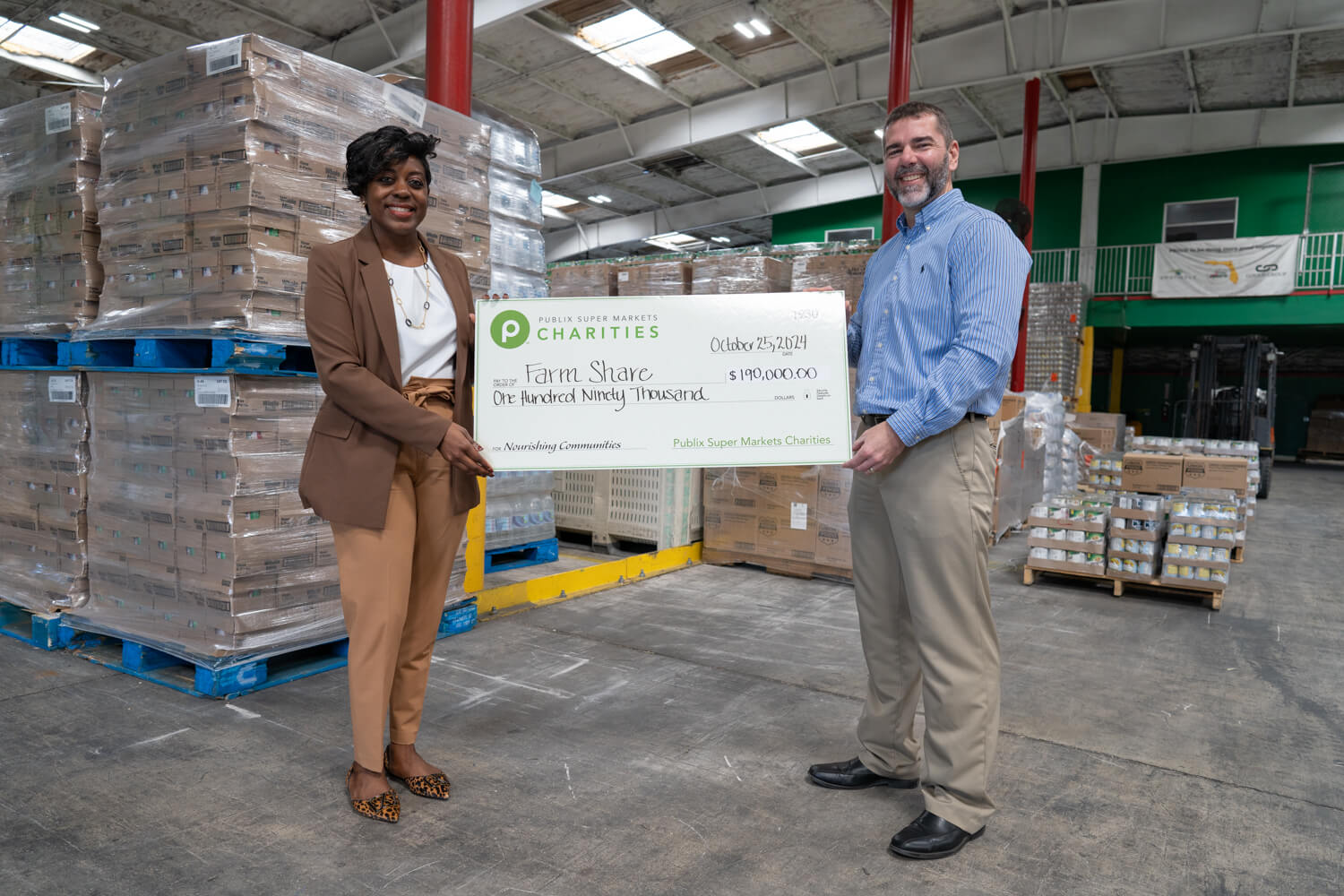 presenting a giant charity check to Farm Share