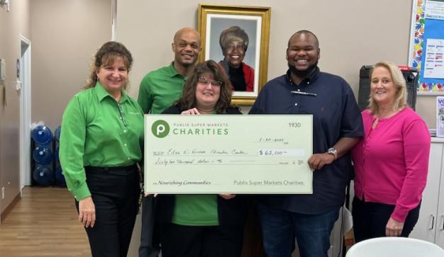 Publix associates presenting a charity check to Edna W. Runner Tutorial Center for $62,000