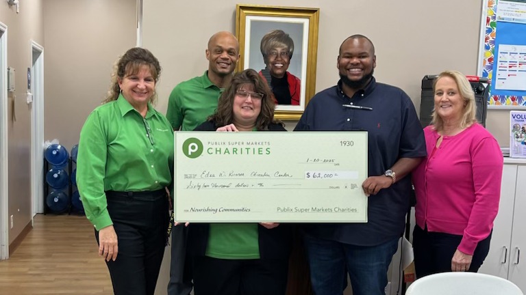 Publix associates presenting a charity check to Edna W. Runner Tutorial Center