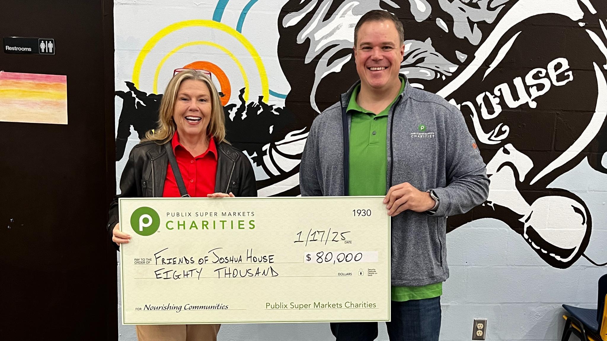 John Doran presenting a charity check to the Friends of Joshua House