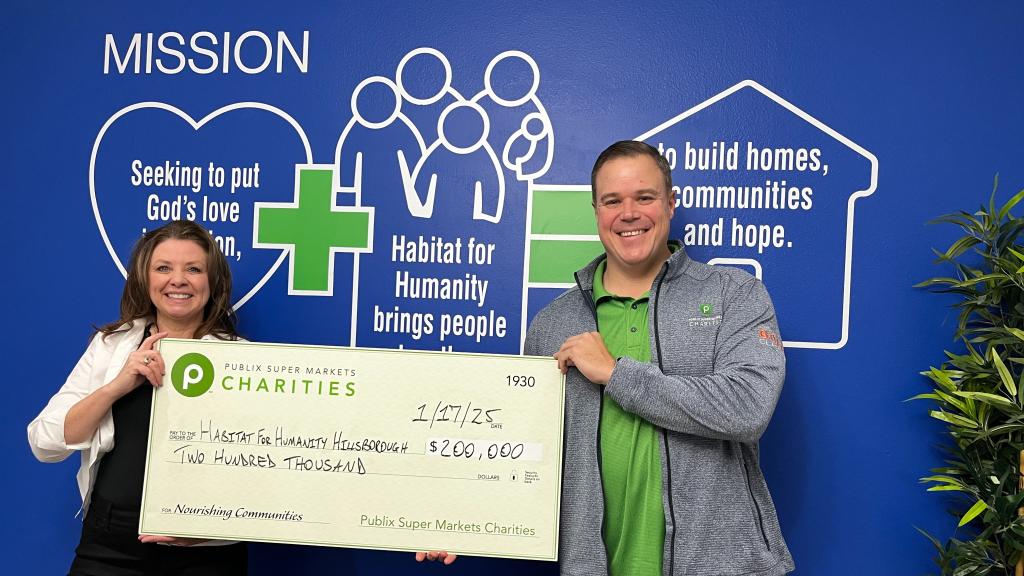 Publix associate presenting a charity check to the Habitat for Humanity of Hillsborough County