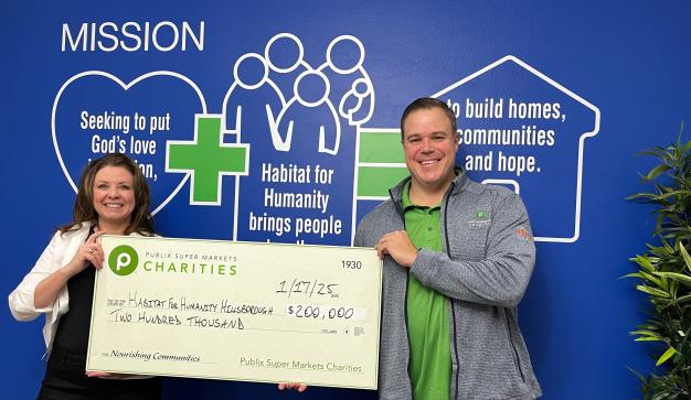 Publix associate presenting a charity check for $200,000 to the Habitat for Humanity of Hillsborough County