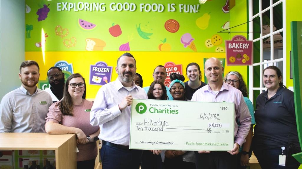 Publix associates presenting a giant charity check to EdVenture