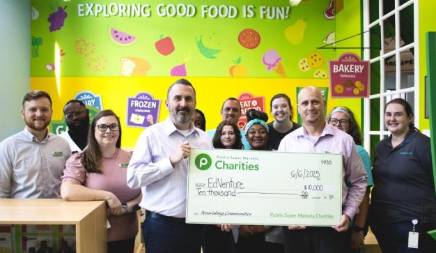 Publix associates presenting a giant charity check to EdVenture