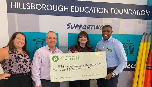 Presenting a charity check to Hillsborough Education Foundation