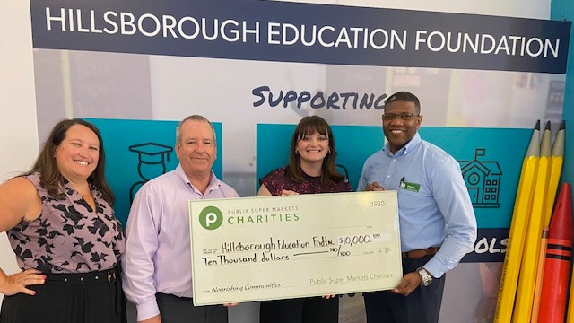 Presenting a charity check to Hillsborough Education Foundation