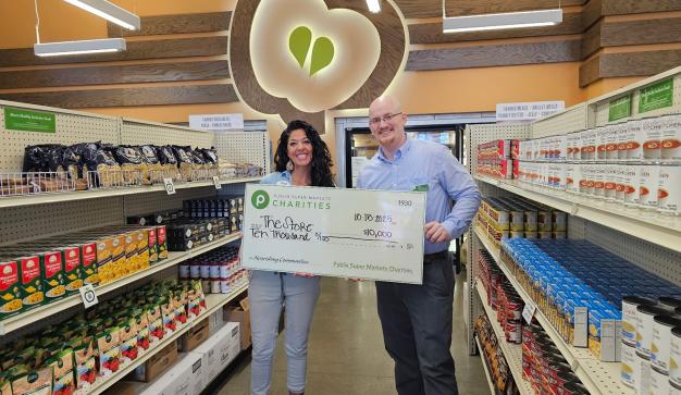 Publix manager presenting a giant charity check for Heaven South