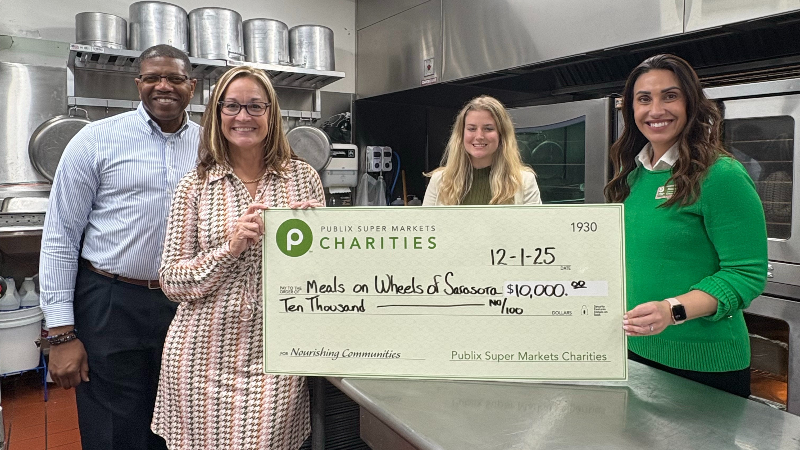 presenting a giant charity check to Meals on Wheels of Sarasota