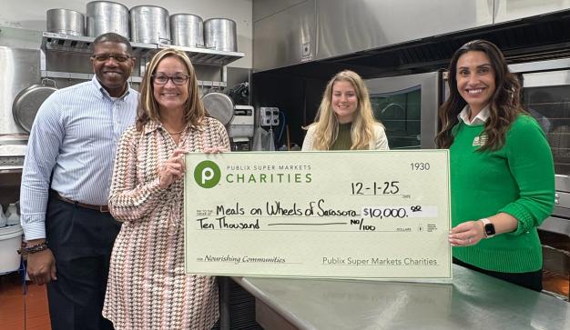 presenting a giant charity check to Meals on Wheels of Sarasota