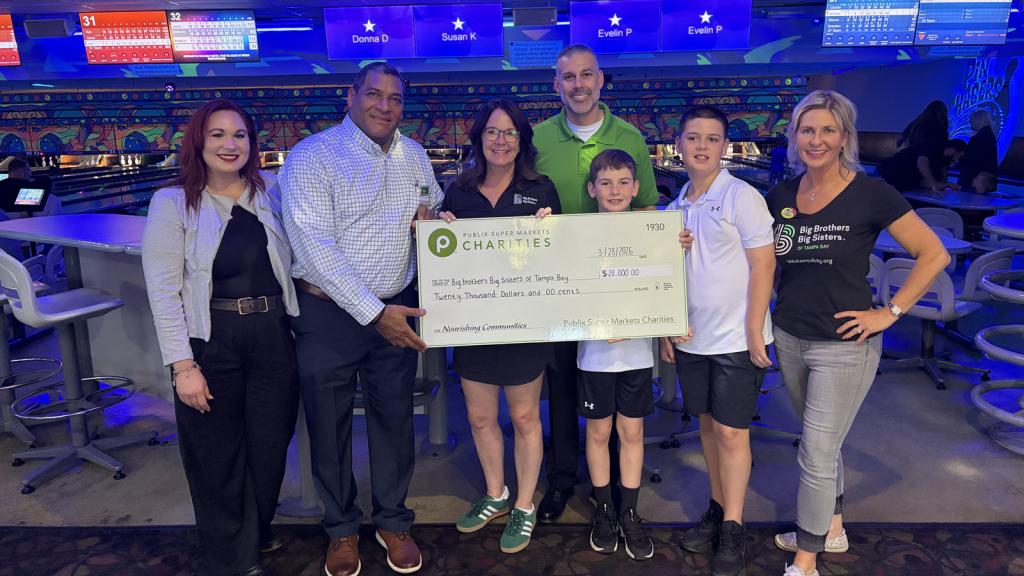A group of people holding a large check for $20,000 from Publix Super Markets Charities to Big Brothers Big Sisters of Tampa Bay.