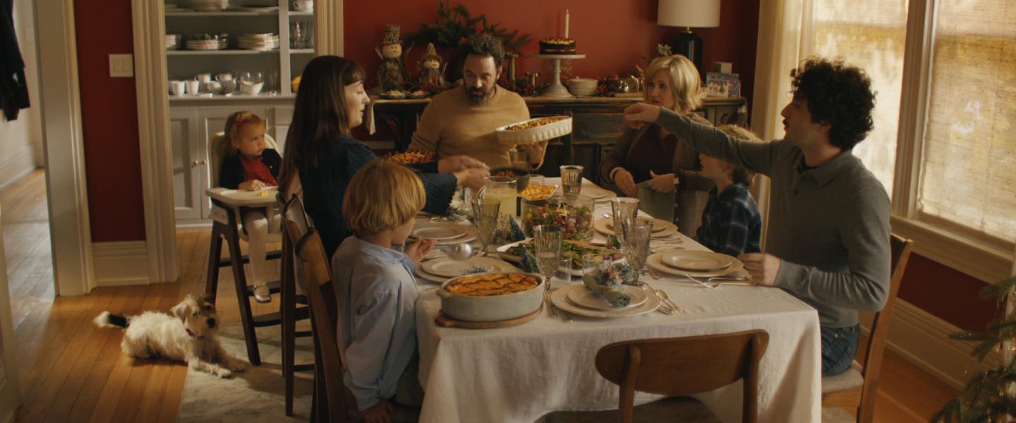 family gathered around christmas table