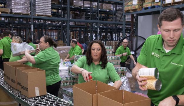 Over 10 Publix serves associates packing food donations at a food bank