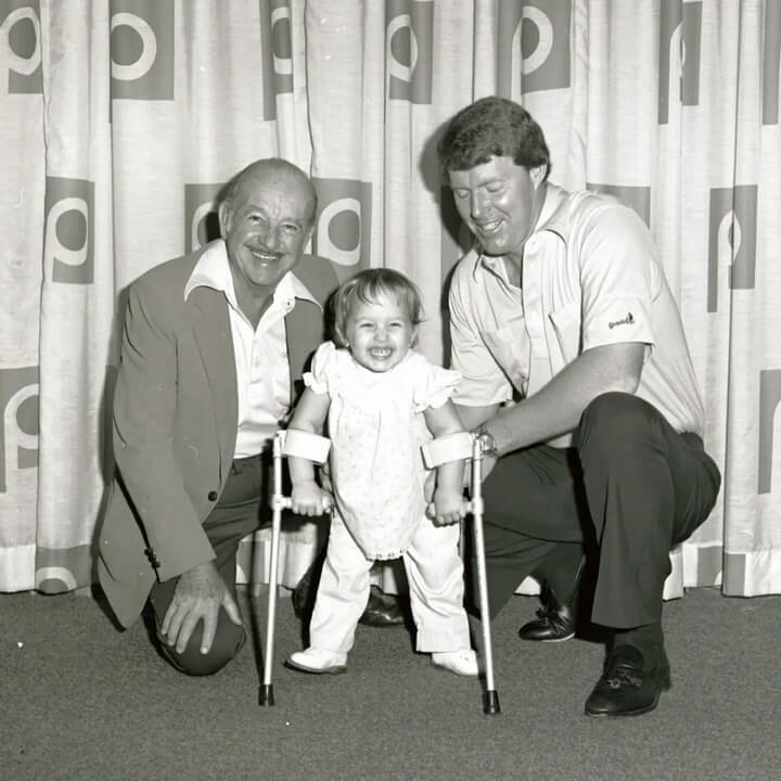 Publix founder Mr. George Jenkins poses with a young girl