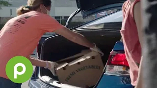 woman loading boxes in a car