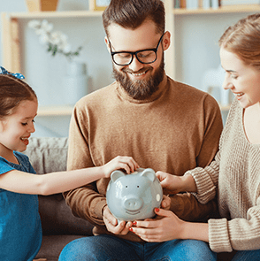 Mom and Dad holding a piggy bank for daughter