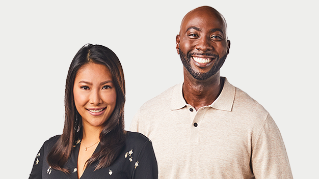 Woman and man in corporate outfits smiling